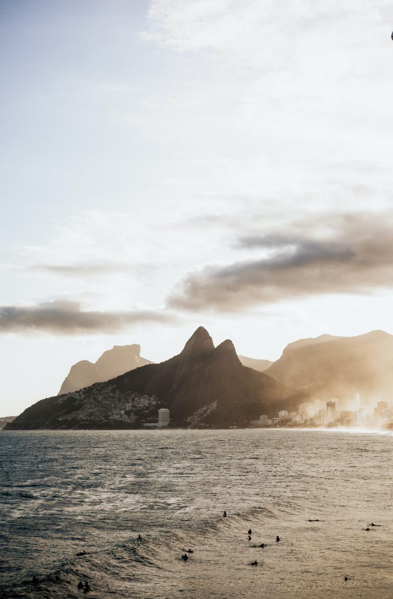 Image of sugar loaf moutain in Rio against the sunlight with the ocean in front. Reminds you how you want to bring foreign investment to Brazil and get the investor visa.