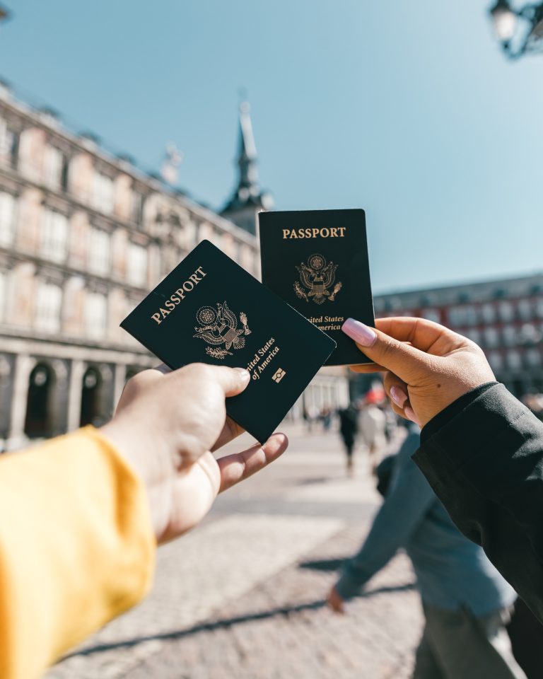 two people holding out their american passports